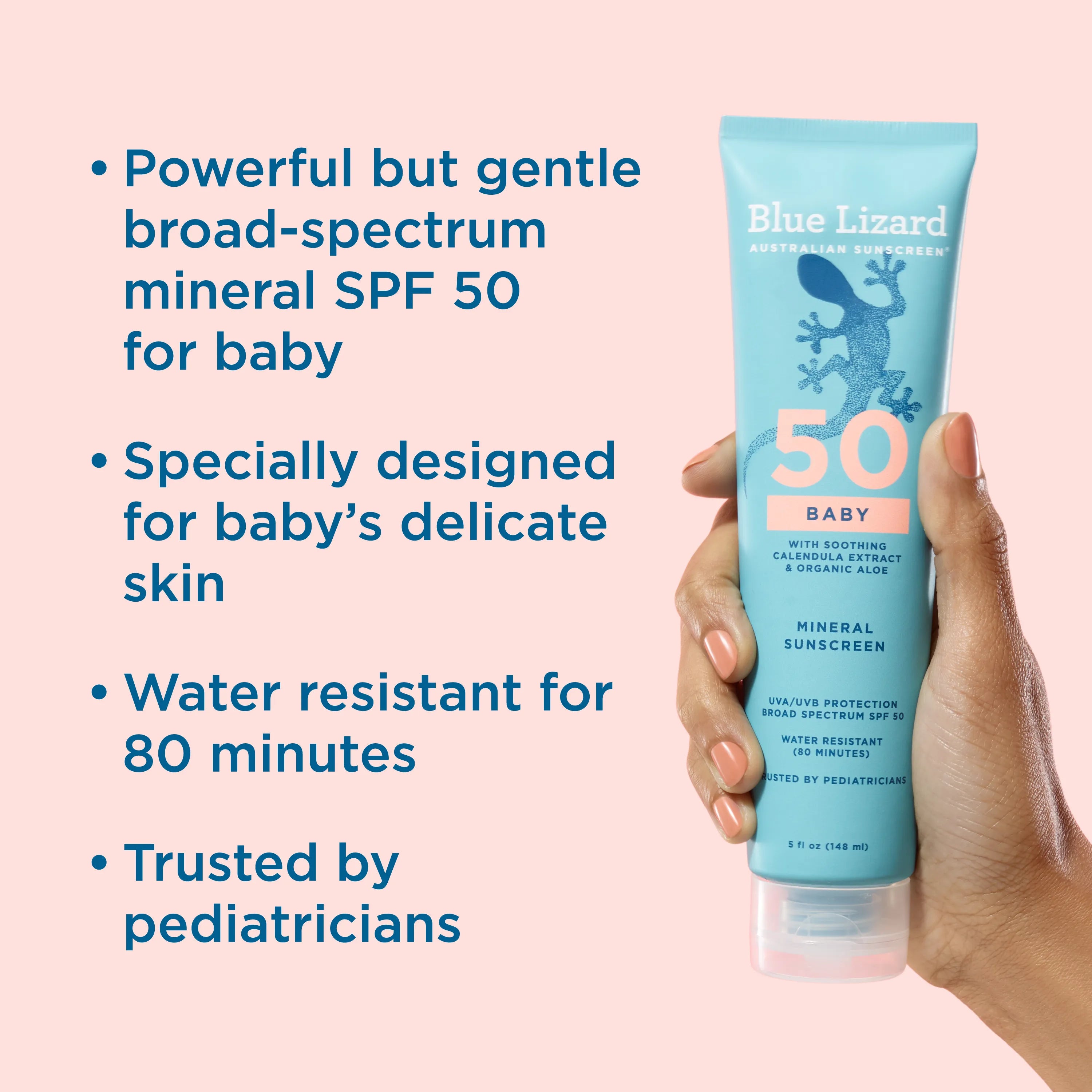 Blue Lizard Baby sunscreen tube held by a hand with product details on a pink background